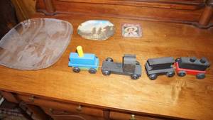 lot 28 image: Four Piece Small Wooden Train--A Glass Serving Tray--A Collectible Plate W A Home & Trees Scene--A Tray WA Girl With Coca Cola Bottle In Her Hands