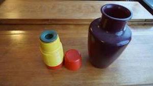 lot 50 image: Black Ceramic Vase--An Aladdin (Red & Yellow) Thermos