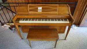 lot 80 image: Acronic Piano--Has Slide Cover To Cover The Piano Keys--Made By Baldwin--On Casters--Piano Bench W Lid To Store Music Books
