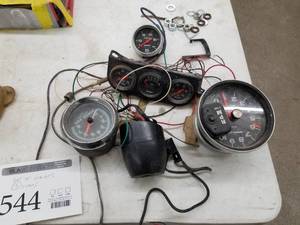 lot 544 image: Lot of (5) Auto Meter Sport-Comp Automotive Gauges - Tach with Rev Limiter, Oil Pressure, Misc. Tach Gauges