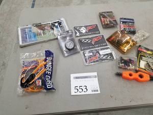 lot 553 image: Automotive Parts and Accessories - Bungee Cords, Classic License Frame, Spectre Fuel Pressure Gauge, Corvette Emblems, Hood & Deck Pinning Kit, Racing Wire Separators, Adjustable Timing Tab, Misc. Parts