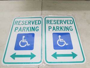 2 handicap reserved parking signs b...