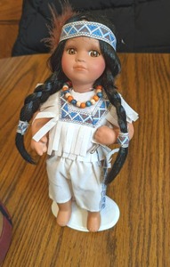 9 Porcelain Native Doll on stand a...