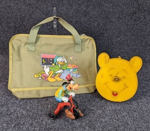Vintage Disney Lot - 1977 Goofy Riding Trike, 1975 Pooh Bear Radio (Untested), and 1960s Donald Duck Bookbag