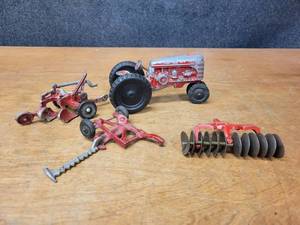 lot 20 image: Vintage Cast Aluminum Toy Tractor w Attachments - 2 Bottom Plow, Sickle Mower and Disc
