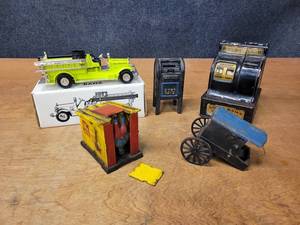 lot 24 image: Antique Uncle Sams Coin Bank, ERTL 1926 Seagrave Fire Truck and Assorted Cast Iron Toys - Cast Iron Toys look like Reproductions