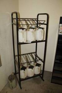 lot 129 image: Metal Storage Rack  with (6) Plastic Pour Jugs