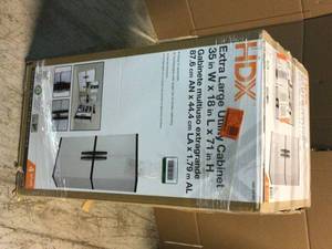 lot 15 image: HDX Plastic Freestanding Garage Cabinet in Gray (35 in. W x 71 in. H x 18 in. D) Customer Returns See Pictures