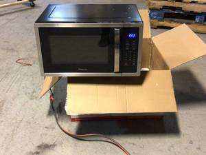 lot 42 image: Magic Chef 1.6 cu. ft. Countertop Microwave in Stainless steel with Gray Cavity Customer Returns See Pictures