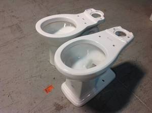lot 28 image: Lot of 2 of American Standard Cadet  Powerwash Triangle Tall Height  Round Toilet in White, Seat Not Included Customer Returns See Pictures
