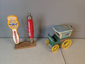 lot 35 image: Vintage Vendome Jim Beam Wagon Decanter, along with Budweiser Beer and Newcastle Brown Ale Tap Handles - A