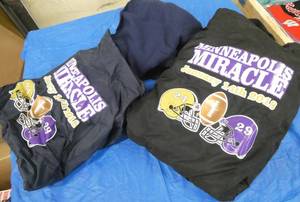 Two Minneapolis Miracle Blankets in a bag, one black, one blue