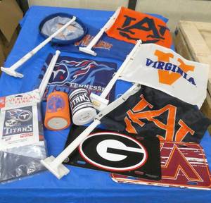 A bunch of car window flags, koozies, helmet mugs, and Emmet Kelley bobblehead