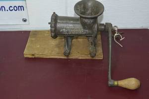 lot 13 image: Antique meat grinder with extra blade