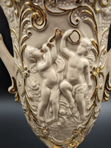 lot 271 image: Cream and Gold Double Handled Cherub Vase
