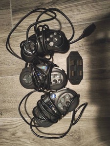 lot 152 image: Three Sega Genesis Remotes & Multi-Player Adapter