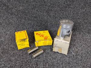 lot 12 image: Suzuki K10 Piston STD Part No. 12110-03971, Suzuki Piston Part No. 12110-17400 for Various 1969 Models, Suzuki Piston Pins Part No. 00031-01140 NOS