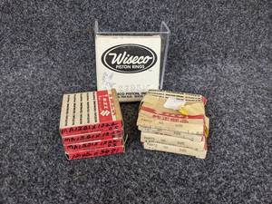 lot 33 image: Lot of (9) Piston Rings from Suzuki and Wiseco - MA1321X13220.5, 12140-03981, 3121X3122, 2795LC NOS