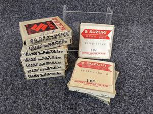 lot 34 image: Lot of (10) Suzuki Piston Rings - Part Nos. 12140-10730, 12140-10010, 12140-01010, 12140-03701, 12140-03701, 00037-45145, and 12140-02700 NOS