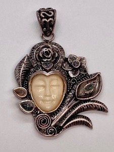 lot 18 image: Unique and Elaborate Sterling Face Carved Pendant