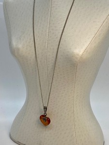 lot 38 image: Heart Shaped Amber Pendant on Sterling Chain