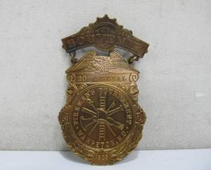 lot 279 image: Antique 1903 20th Annual FIREMENS Tournament Brass Badge