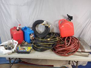 lot 96 image: Tarp, Garden Hoses, Solar Lights, Gas Jugs