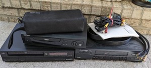 lot 24 image: Oritron DVD Player, Mitsubishi DVD Player, Shintom VHS Player & Case with Cassette Tapes Julio Iglecias, Neil Diamond, Garth Brooks, & More
