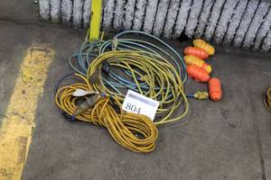 lot 804 image: Extension Cords (x3), Plug Protectors (x5)