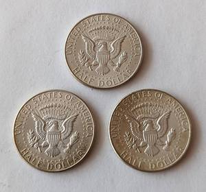 lot 220 image: Three 1964 Kennedy Half Dollars