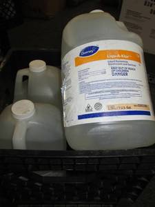 black milk crate with 4 gallons of ...