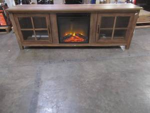 lot 423 image: Walker Edison Portsmouth Classic 2 Glass Door TV Stand for TVs up to 80 Inches, 70 Inch, Rustic Oak, AZ70CSGDRO - Little Loose - Some Finish damage on RH Side Front.