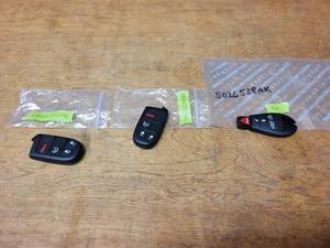 lot 815 image: NOS - Mopar FOBs - (2) Part No. 68066350AG and (1) 5026538AK