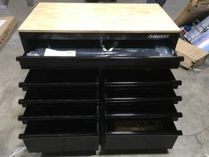 lot 17 image: 46 in. W x 24.5 in. D 9-Drawer Gloss All Black Deep Tool Chest Mobile Workbench with Hardwood Top by Husky Customer Returns See Pictures