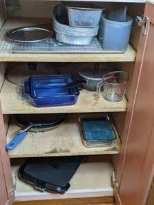 lot 67 image: Contents of Kitchen Cabinet Electric Skillet, Baking Pans, Pots and More