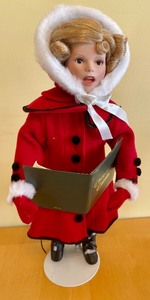 lot 82 image: The Shirley Temple Christmas Doll Collection Doll- The Little Caroler
