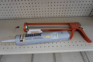 Caulk gun and adhesive