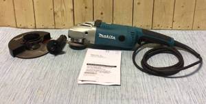 Makita 15 Amp 7 in. Corded Angle Grinder with Grinding wheel, Side handle and Wheel Guard Customer Returns See Pictures