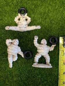 lot 53 image: 3 Piece Cast Iron Michelin Man Figures