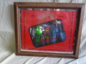 Carling Black Label faux wood framed mirror. 24 x 20. As shown.