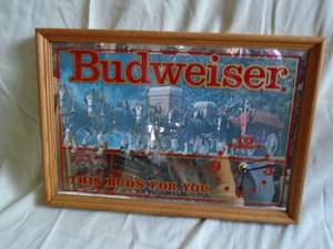Budweiser mirror clock. Wood frame. 19 x 13. Clock works. As shown.