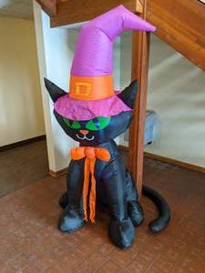 lot 290 image: National Tree Company 6-12 Inflatable Lighted Black Cat Halloween Decor - N