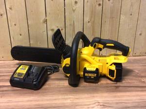 lot 94 image: DEWALT 12 in. 20V MAX Lithium-Ion Cordless Brushless Chainsaw with (1) 5.0Ah Battery and Charger Included Customer Returns See Pictures