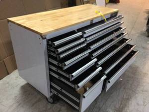 lot 112 image: 62 in. 14-Drawer 24 in. Deep Stainless Steel Mobile Workbench with Solid Wood Top by Husky Damaged Wheel Customer Returns See Pictures