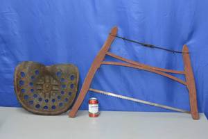 lot 17 image: Cross cut bow saw and vintage tractor seat