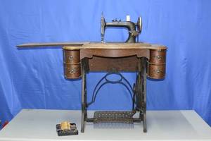 lot 28 image: N. E. Queen Treddle Table and sewing machine
