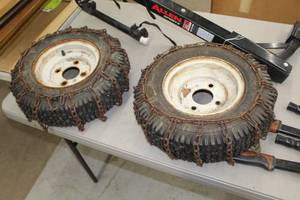 lot 669 image: Lot of (2) Rims 9 4-lug Utility Wheels with Tires and Chains