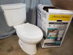 lot 4 image: American Standard Touchless Elongated Chair Height Toilet