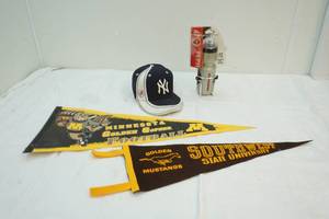 Yankees hat and university pennants
