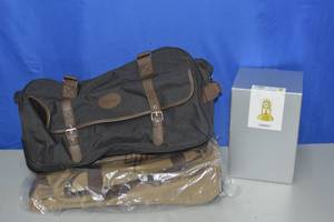 2 rolling luggage bags and a tabletop clock